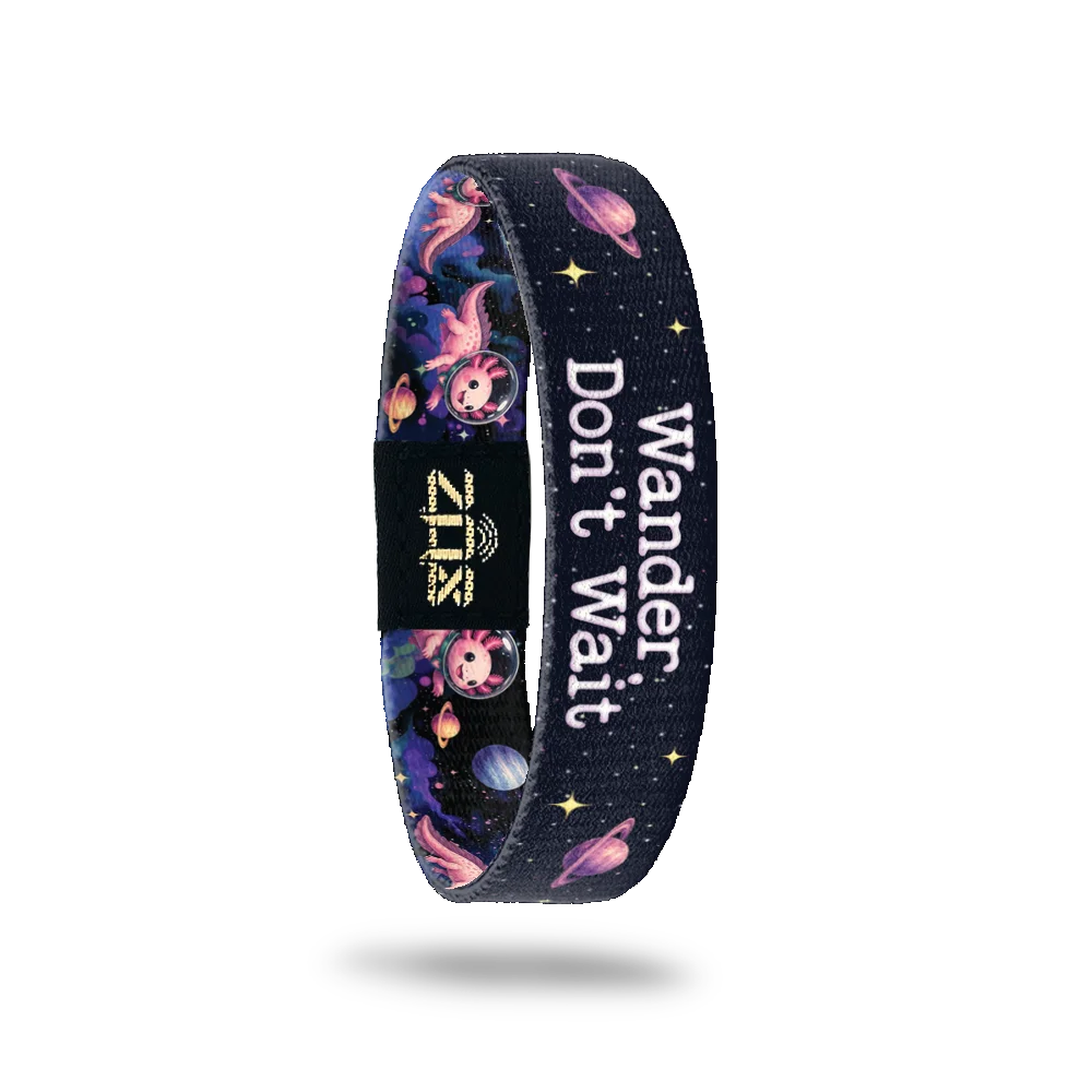 Inside of the Wander Don't Wait bracelet, with the words Wander Don't Wait across the cosmic print