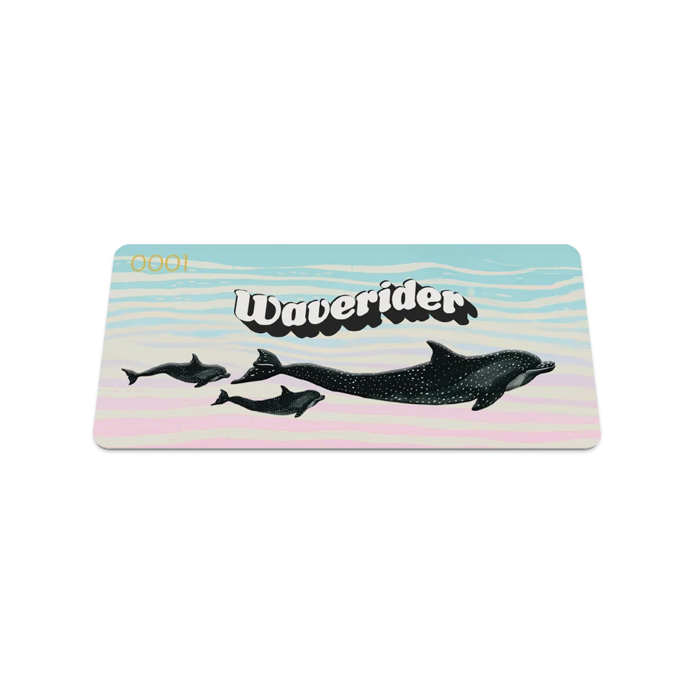 Product photo of the front of the Waverider collector's card, featuring a pastel gradient background of soft blue and pink. The design includes silhouettes of four dolphins swimming. Bold, retro-style white text outlined in black reads "Waverider" across the top. The serial number "0001" is visible in the upper left corner.