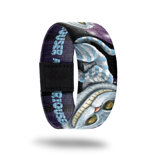 Outside Design of Curiouser: dark purple sky with blue and white Chesire cat throughout the strap