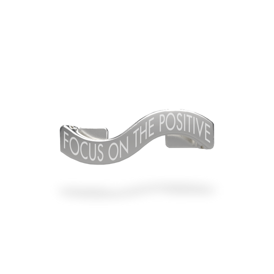 This is a charm that fits ZOX single wristbands, lanyards and hoodie strings only. It is made from stainless steel and is silver in color. The words FOCUS ON THE POSITIVE are etched in the metal.