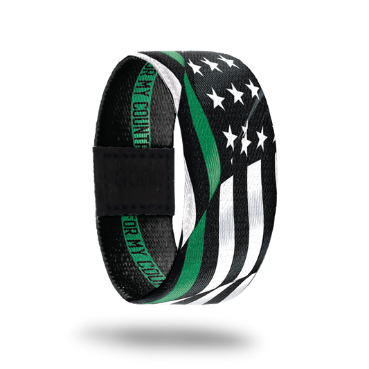 Outside Design of For My Country. wavy black and white United States flag with a line of green for one bottom stripe of the flag