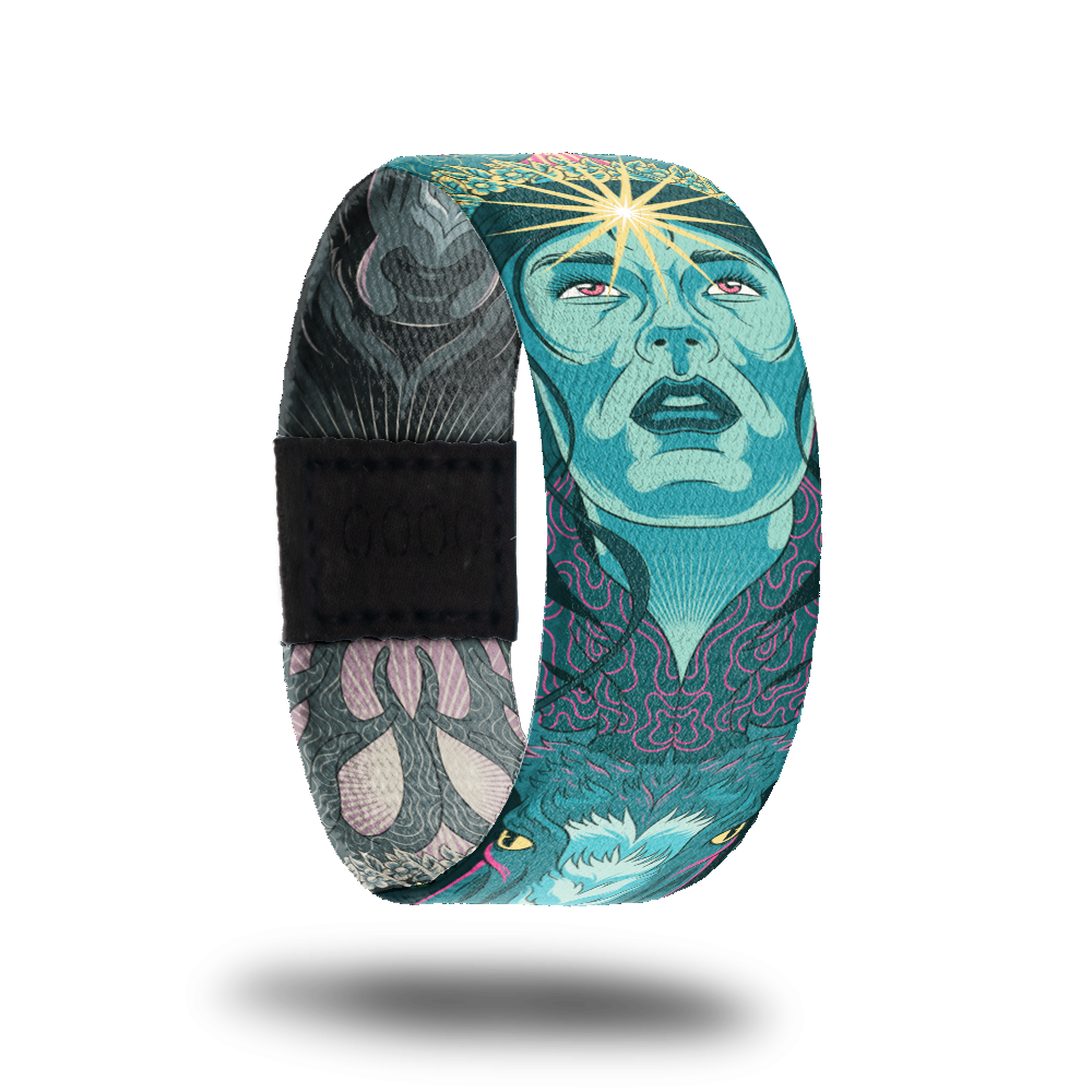 product image of a wristband named Inner Light showing the outside design. The design is hues of blues and greens showing a hand drawn face with a shining star on the person's forehead 