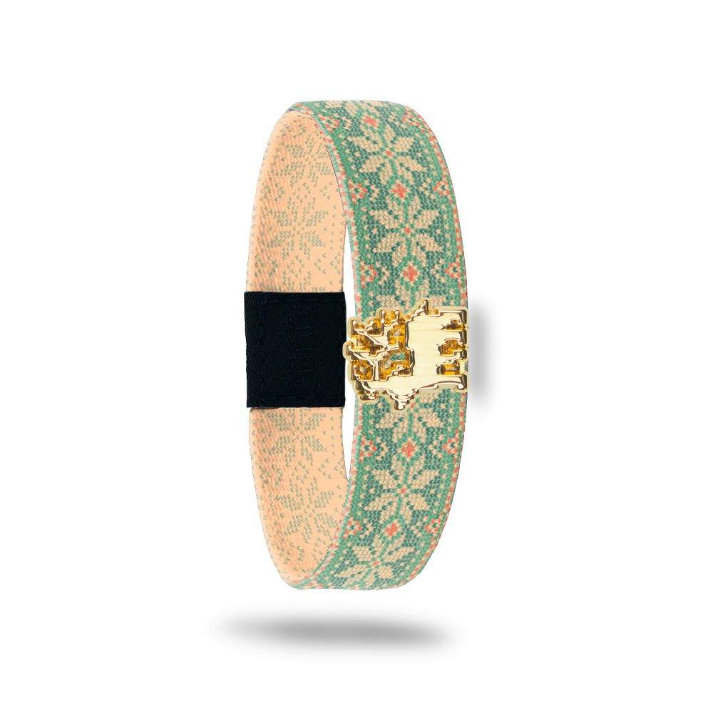 Wristband single with beige and light green vintage sweater design with specs of orange. The design is snowflakes and dots. Comes with a matching charm of a reindeer. The inside reads Joy To The World. 
