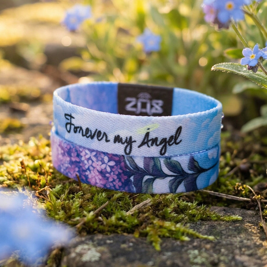 Wristband with 'Forever my Angel' text on a natural background with flowers