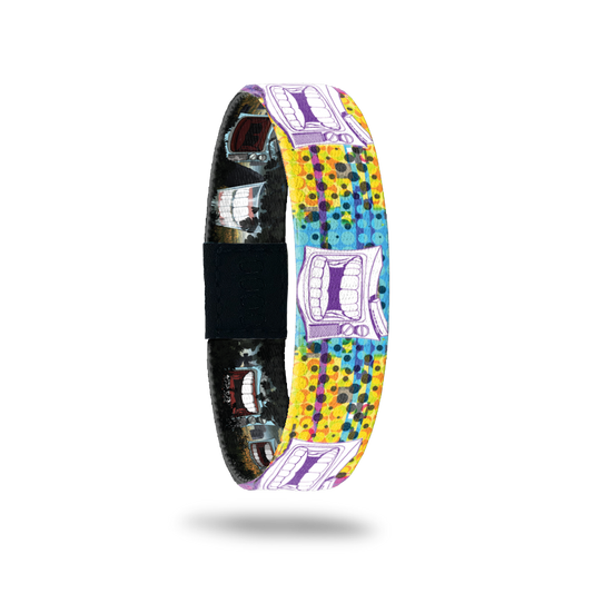 Bracelet is multicolored with yellow, teal and range dots/design. Has an old-school TV with chatter teeth on the design. Comes with a pin of a chatter teeth set. 