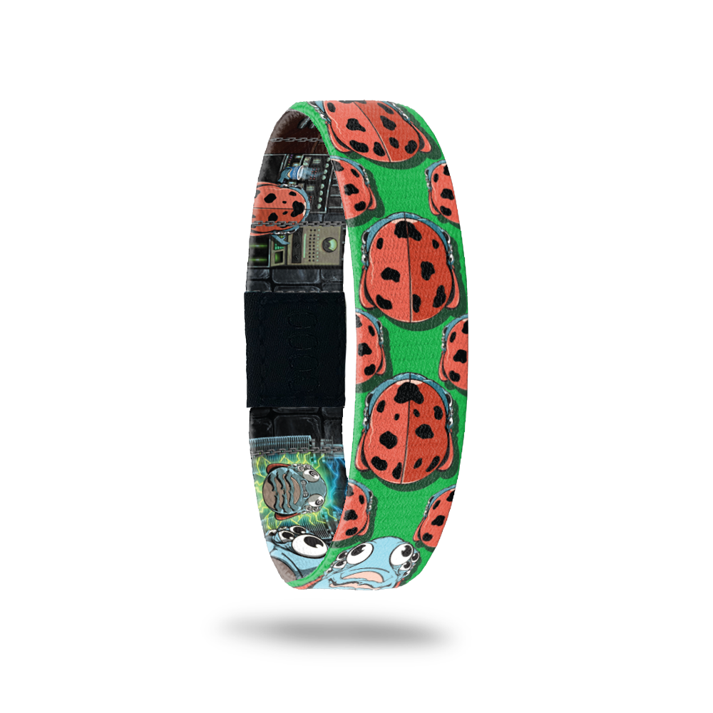 Green bracelet with prints of ladybugs all over. Comes with a matching pin of a monster ladybug that looks scared. 