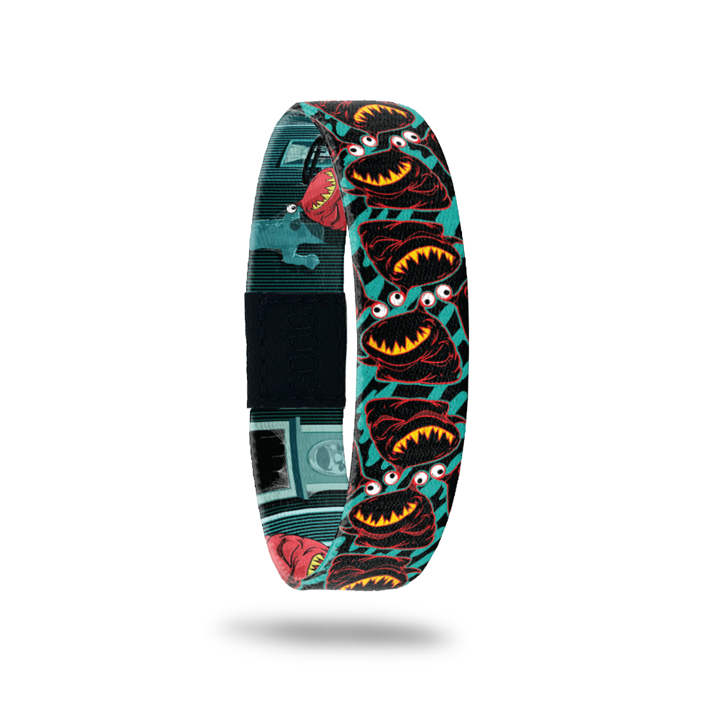 Product photo of the outside of 2020 - Day 20 - Ms. Oh That's Nice: turquoise and black design with repeating black and red monster with sharp yellow teeth and one eyeball