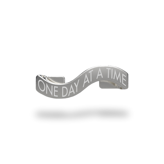 This is a charm that fits ZOX single wristbands, lanyards and hoodie strings only. It is made from stainless steel and is silver in color. The words ONE DAY AT A TIME are etched in the metal.