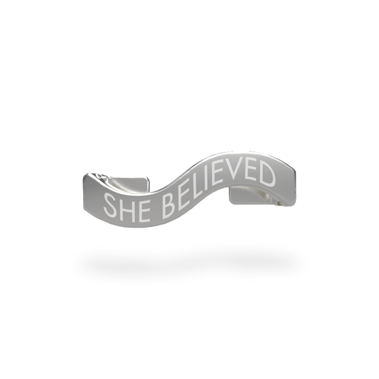 This is a charm that fits ZOX single wristbands, lanyards and hoodie strings only. It is made from stainless steel and is silver in color. The words SHE BELIEVED are etched in the metal.