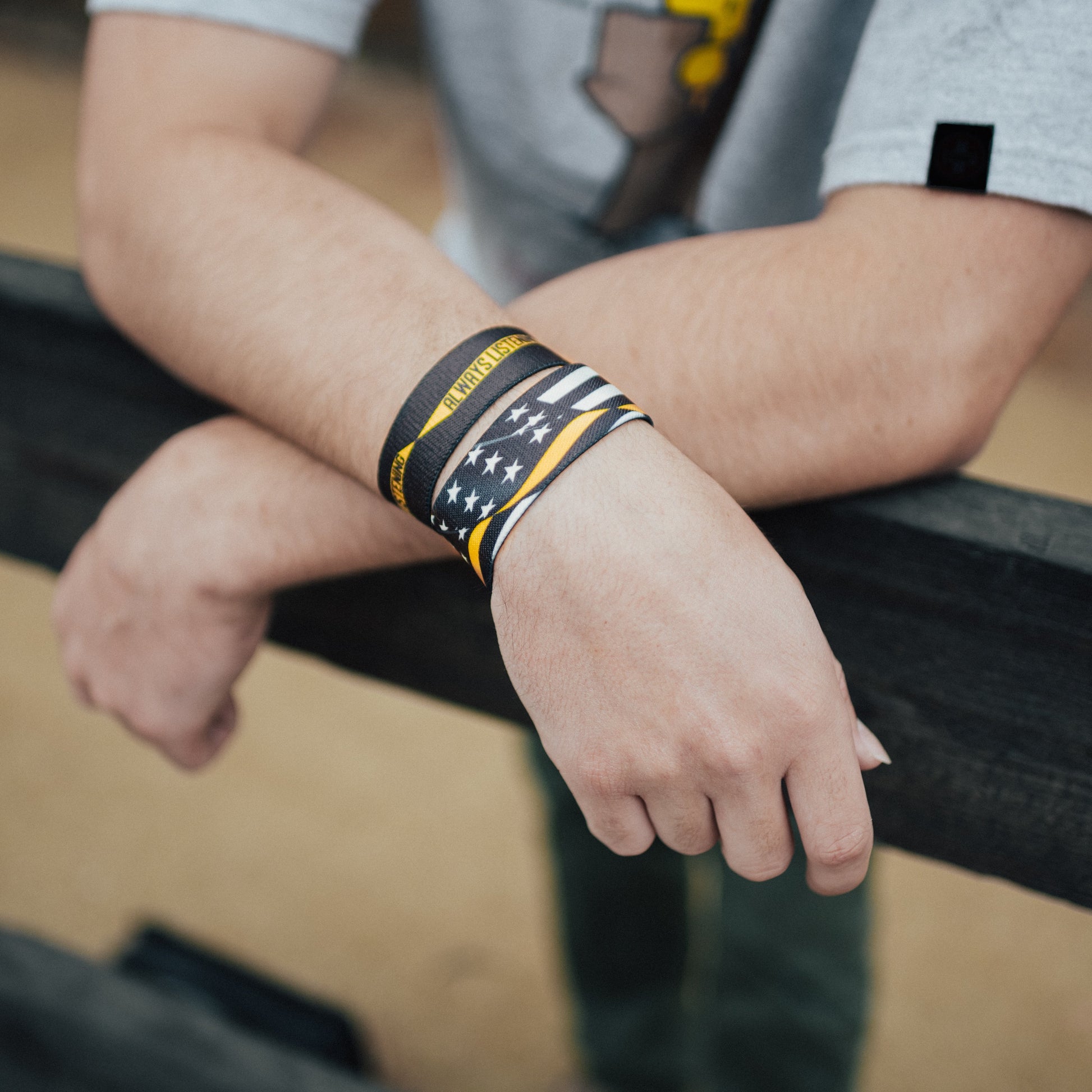 Lifestyle image: close up of two Always Listening straps on man's wrist