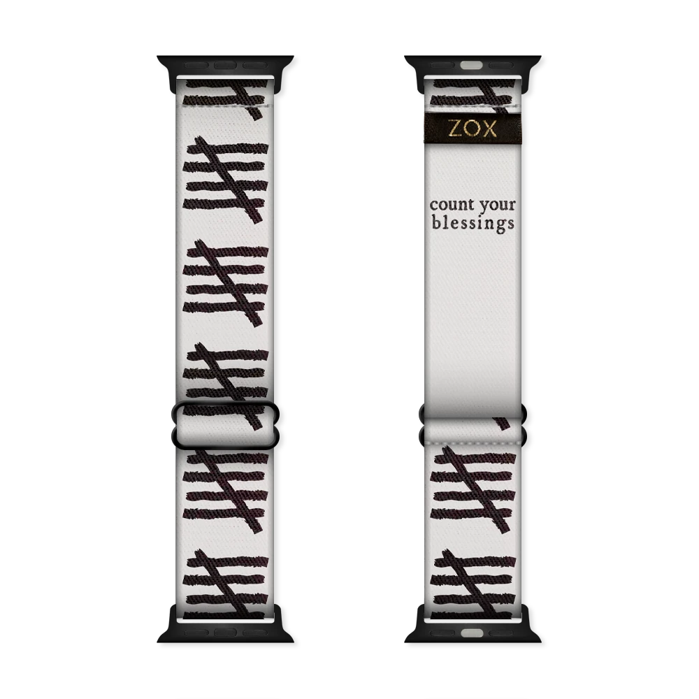 This is a watchband and not reversible. The base color is off-white/light grey. It has tally marks all down the sides of the bands. The inside is the same design and reads Count Your Blessings. 