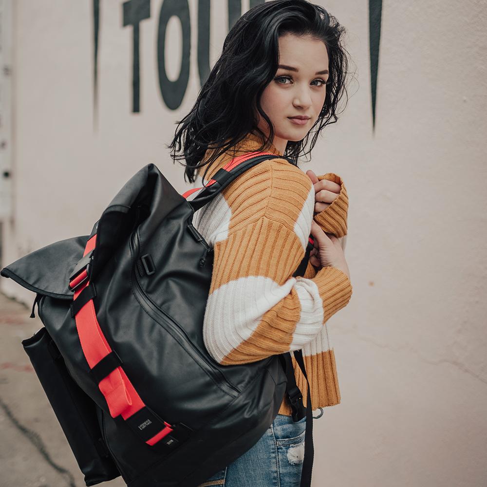 lifestyle photo of the Imperial v2 with a different colored closure strap on a woman's shoulder while looking back at the camera