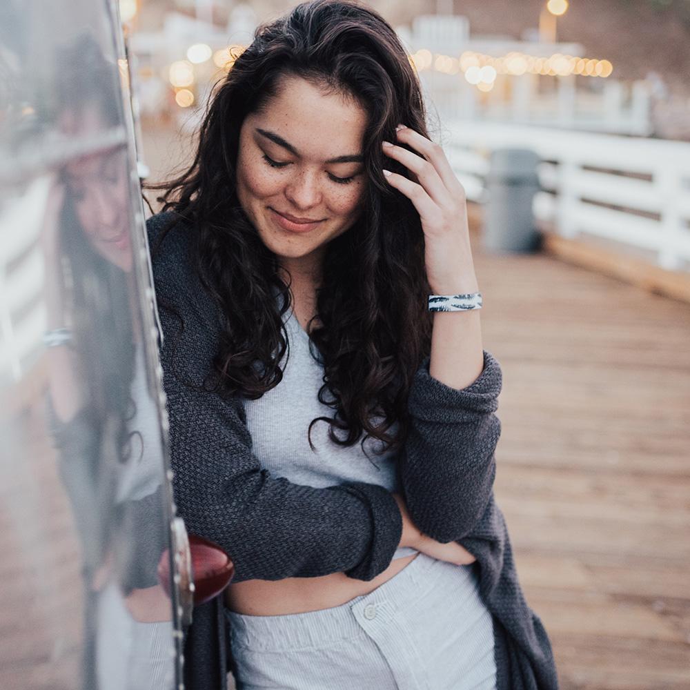 Lifestyle image close up of someone smiling with Flight on their wrist 